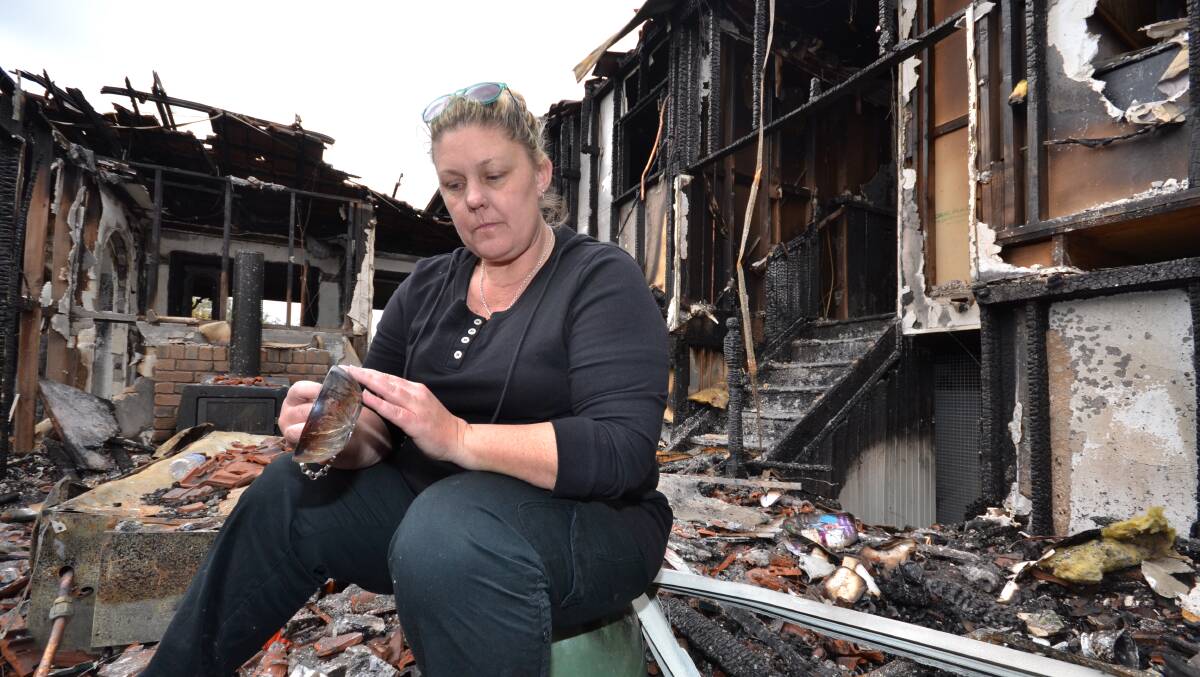 Allison Hokin sits in the destroyed living area of her parents’ Cavanagh Lane home that was gutted by fire last Thursday. 