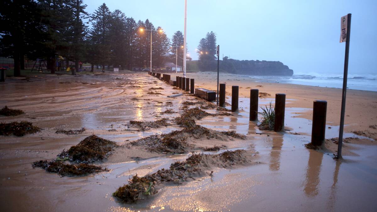 Sand and seaweed washed up on Austinmer beach on Wednesday morning. Picture: KIRK GILMOUR