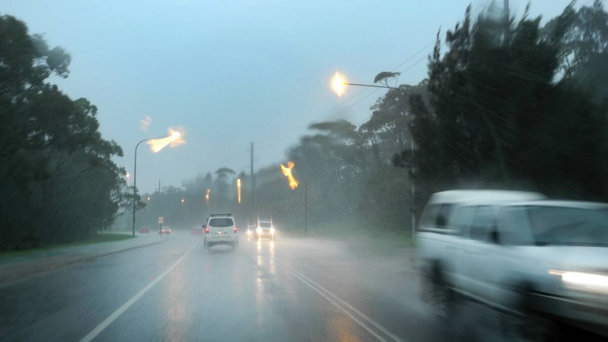 Torrential rain falls on Squires Way near Stuart Park at North Wollongong about 8.30am on Wednesday. Picture: KIRK GILMOUR