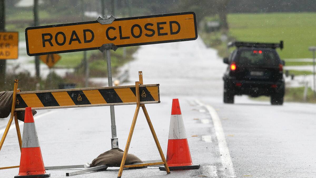 A motorist ignores a road closed sign on the Illawarra Highway between Tongarra Road and Princes Highway at Albion Park on Wednesday. Picture: GREG TOTMAN