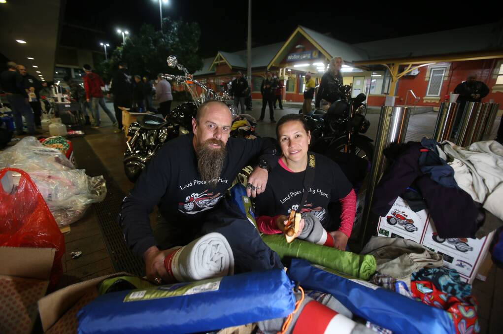 Helping the homeless: Greg and Carla Jenkins handing out food, bedding, clothing and care packs near Wollongong Railway Station on Friday night. Picture: Robert Peet.

