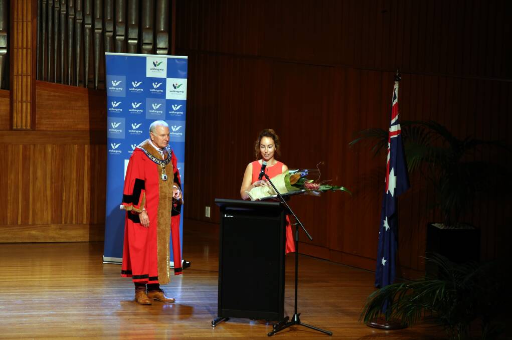Young volunteer: Wollongong Lord Mayor Cr Gordon Bradbery looks on as Wollongong Young Citizen of the Year Madeline Bow accepts her award in front of a packed town hall as part of the Australia Day Citizenship Awards. Picture: Sylvia Liber.