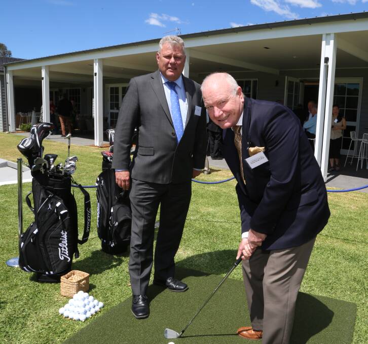 Investment: Dapto Leagues chief executive David Hiscox helps Wollongong Lord Mayor Gordon Bradbery get into the swing. Pic: Greg Ellis.