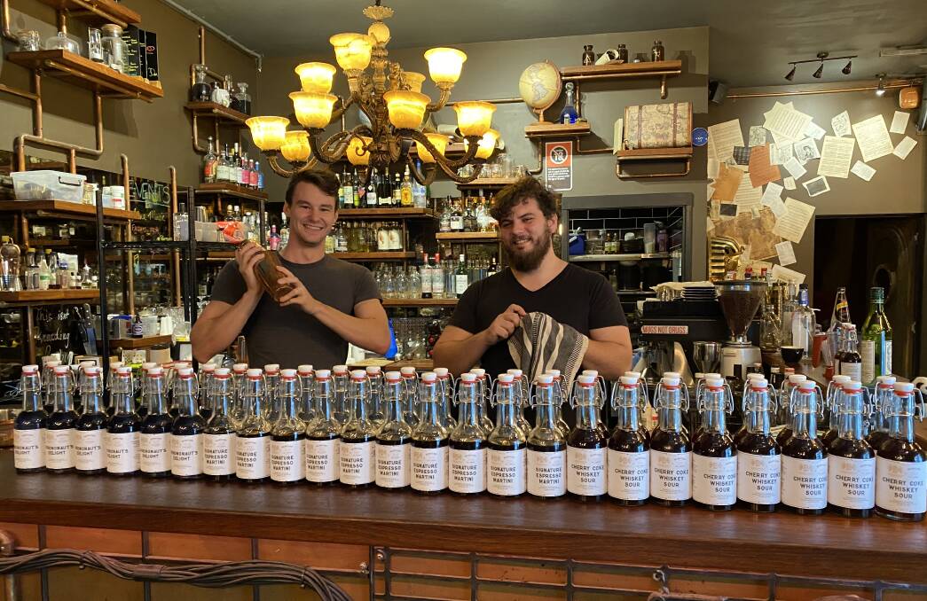 The great cocktail escape: Manager Mitchell Bloomfield and bar manager Orion Leppan Taylor making takeaway cocktails in bottles at Breakout Bar and Escape Rooms in Wollongong. 