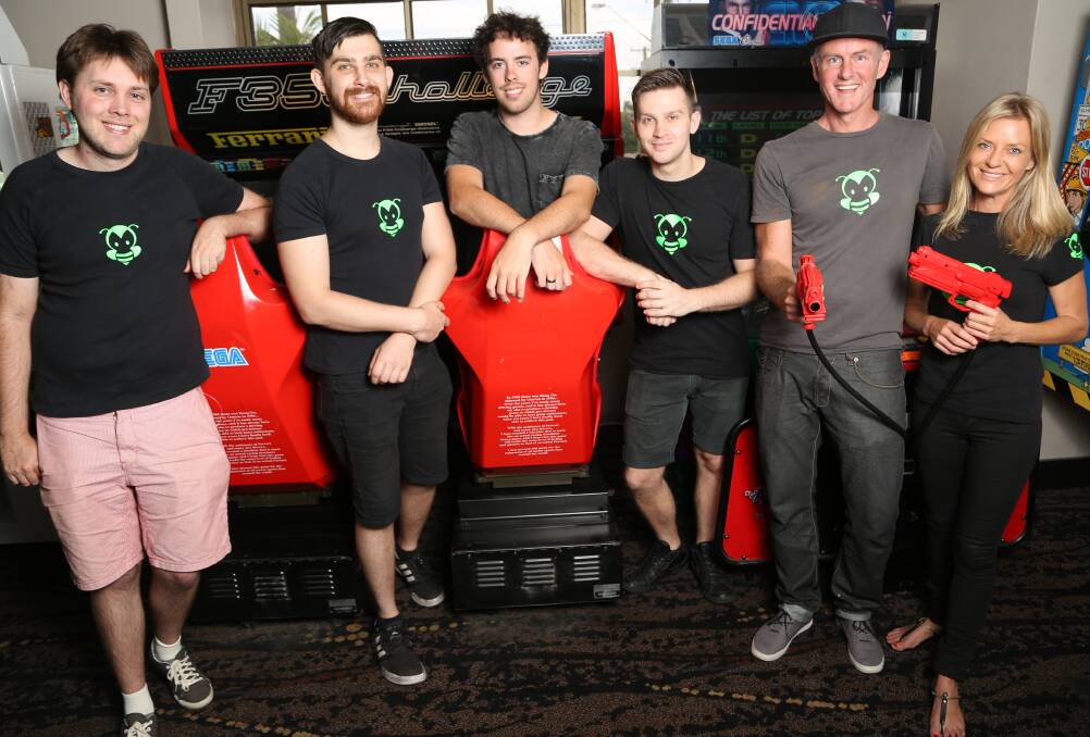 ON THEIR GAME: Wollongong game developers Mitchell Moore, Andrew Papanikolaou, Myles Cooley, Byron Papanikolaou, Michael Gardiner and Gretchen Armitage have run their games in Tasmania signed a deal with TimeZone to take on the world of gaming using smartphones as controllers. Picture: GREG ELLIS