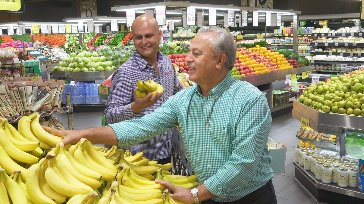 Family and regional pride: Mitchell Kambouris and his father Chris Kambouris are keeping suppliers and customers on the South Coast happy with the fruits of their buy local produce philosophy at Mitchell's Markets.
