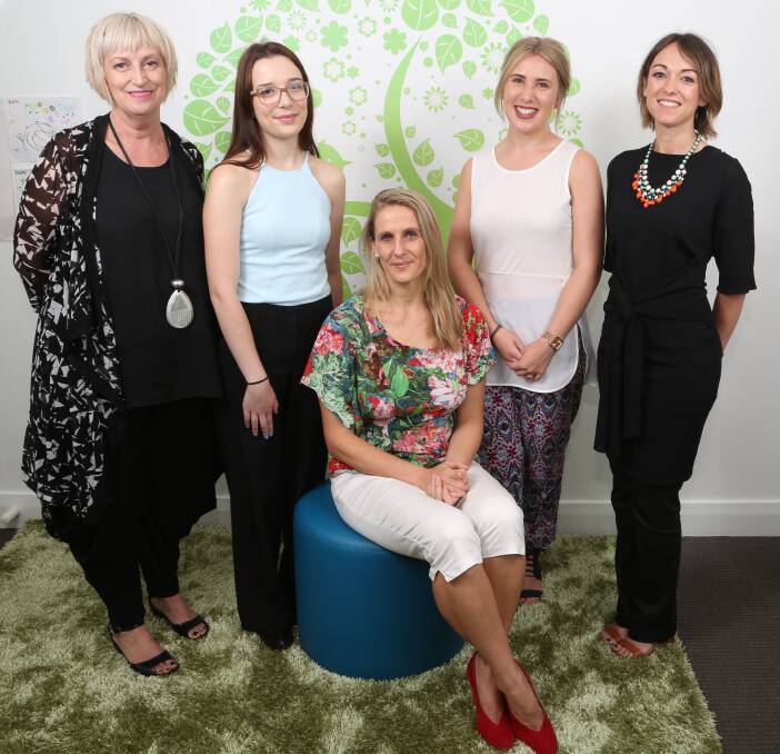 Catalyst for opportunity: UOW's Dr Lois Burgess, students Siobhan Kelly and Alyss Phillips, LBPR's Lisa Burling and first client Catherine Andrews (sitting) at the Catalyst office in Wollongong. Picture: Greg Ellis.