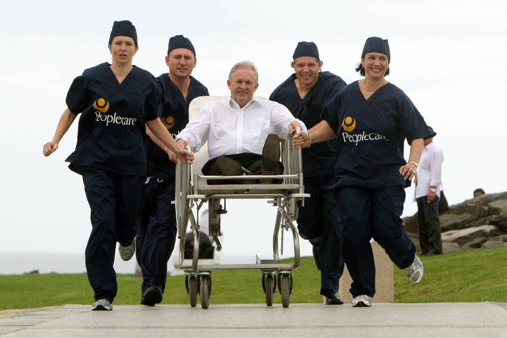 Community: Michael Bassingthwaighte & Peoplecare's Kelly Baker, Chris Stolk, Tory Acri & Anita Mulrooney prepare for the Australia Day hospital bed race in 2010.