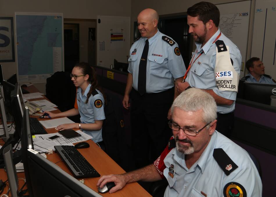Full alert: NSW State Emergency Service (SES) Acting Commissioner Greg Newton and llawarra/South Coast Incident Controller Ashley Sullivan in the busy SES control room on Sunday afternoon. Picture: Greg Ellis.
