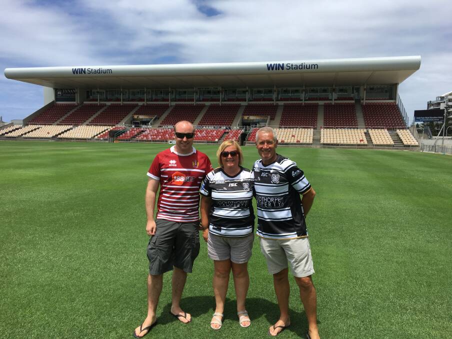 Love the Gong: A photo of Wigan supporter Paul Bolton with Hull fans Julie & Andy Harper at WIN Stadium is attracting plenty of attention on social media.
