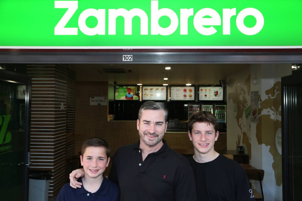 Sporting entrepreneur: Former ironman and Mexican food restaurant chain owner Jonathan Crowe with his sons Nathaniel and Emerson at Zambrero Wollongong. Picture by Greg Ellis.
