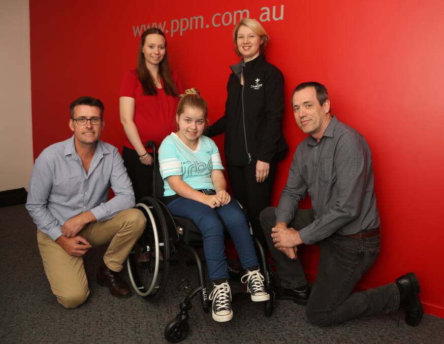 Easter surprise: Clara Bates (centre) shows off her new wheelchair to PPM's Troy McDonald, Brodie Hodges, Belinda Dawson and Rod Todhunter. Picture: Greg Ellis.


