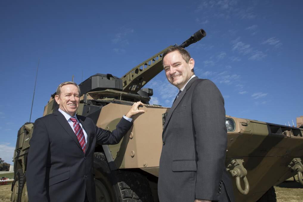 Important agreement could create steel jobs in Wollongong: Bisalloy Steel chief executive and managing director Greg Albert with Rheinmetall Defence Australia managing director Gary Stewart in front of Rheinmetall’s BOXER Combat Reconnaissance Vehicle (CRV).