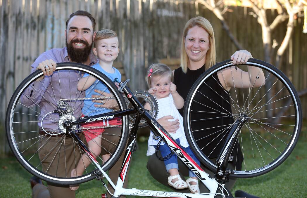 Riding for cause: Luke Rollinson enjoying family support from Eli Rollinson, 3, Harper Rollinson, 1, and Katie Rollinson in preperation for his 12 hour Endure for a Cure ride at Eastern Creek. Picture: Robert Peet
