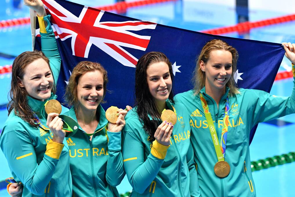 Winning grins: Emma McKeon and her Women's 4 x 100 m freestyle relay team mates with their gold medals after the presentation ceremony in Rio. Picture: Joe Armao