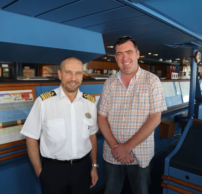 At the helm: Radiance of the Seas Captain Goran Peterson with Destination Wollongong general manager Mark Sleigh on The Bridge helping to navigate a course for more cruise ships to come to Wollongong. Picture: Greg Ellis.

