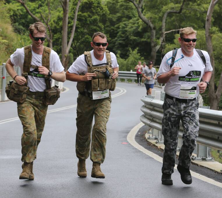 In formation: Australian Defence Force personnel Talin Kennedy, Beau Byers and Brett Channon during the Mount Keira Challenge. Picture: Robert Peet.

