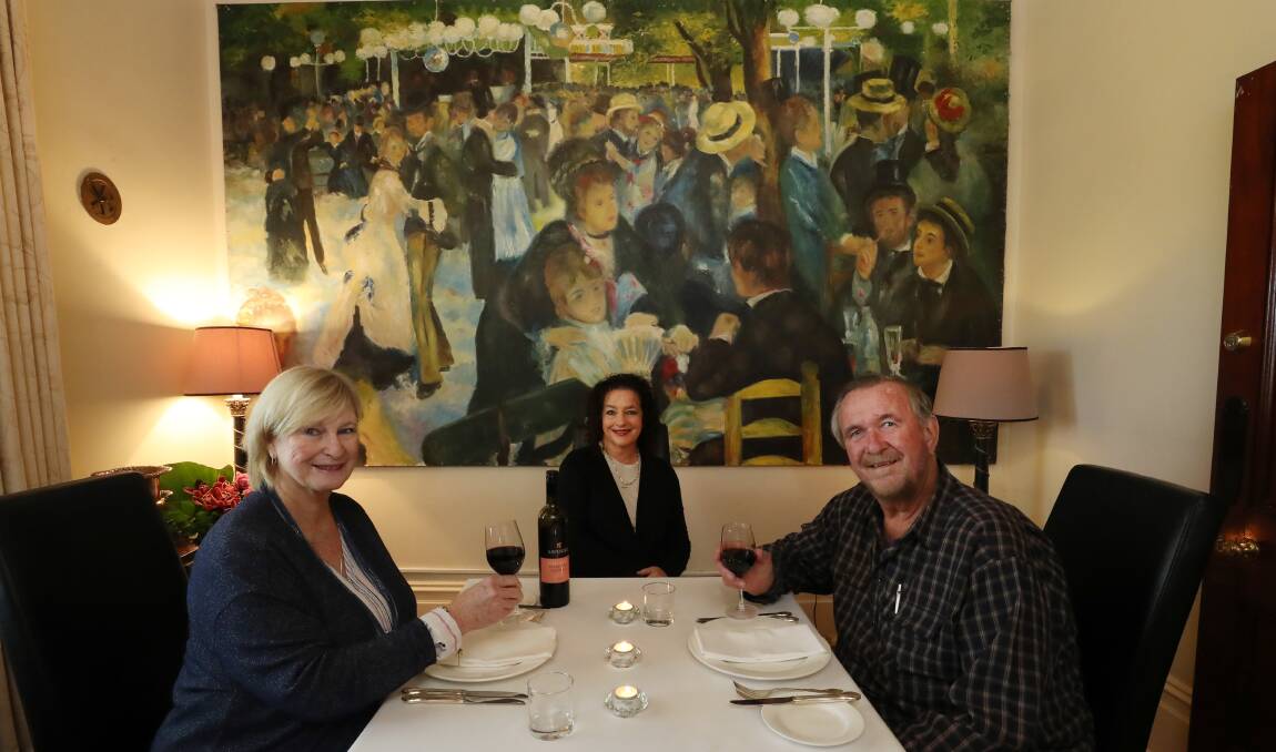 Charcoal Tavern memory: Marianne King, Deborah McCallum and Hilton King soak up the atmosphere and dining experience provided by the giant artwork at Ravensthorpe, Albion Park. Picture: Robert Peet.