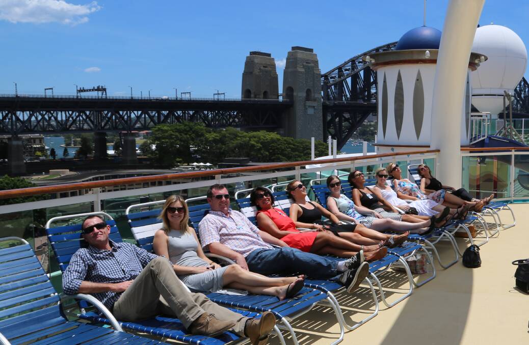 Great way to relax: The Destination Wollongong team put up their feet on some deck chairs after walking many kilometres touring the giant cruise liner. Picture: Greg Ellis.
 