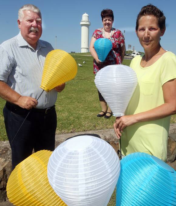 LIGHT THE NIGHT AMBASSADORS: David Campbell, Margaret Biggs and Natasha Jauncey make preparations at Flagstaff Hill where the annual walk for leukaemia research is going to be held on Saturday night. Picture: Robert Peet