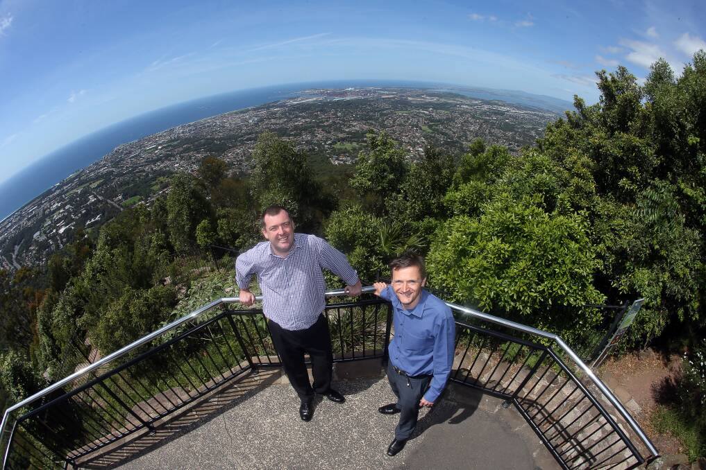 SHIP AHOY: Tourism boss Mark Sleigh, of Destination Wollongong, and cruise expert Toby Biddick, of Abercrombie and Kent, at Mt Keira Lookout one year to the day before the arrival of Royal Caribbean's Radiance of the Seas.
Picture: Robert Peet