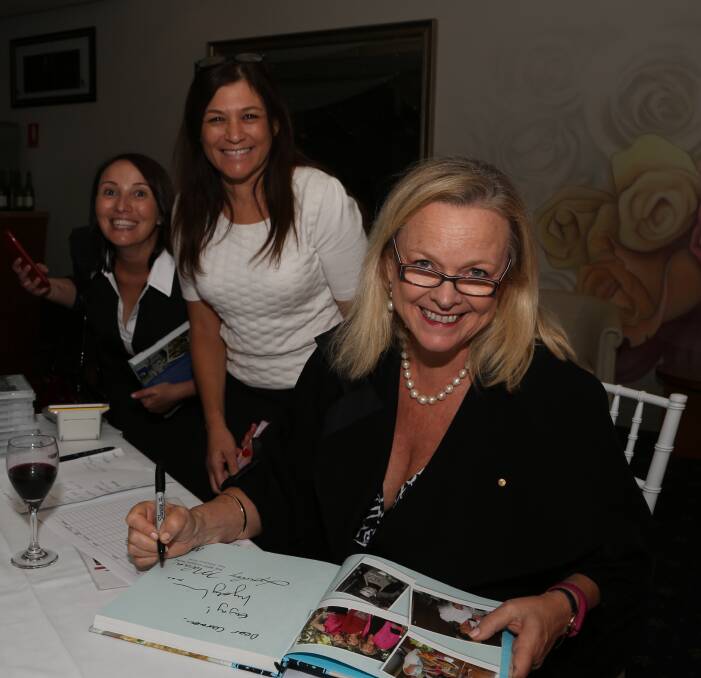 Inspirational memory and tribute to a much loved son: Celebrity chef, TV presenter and author Lyndey Milan, of Jamberoo, signing some of her many books at the Inspire lunch at Villa D'Oro on Friday. Picture: Greg Ellis.
 
