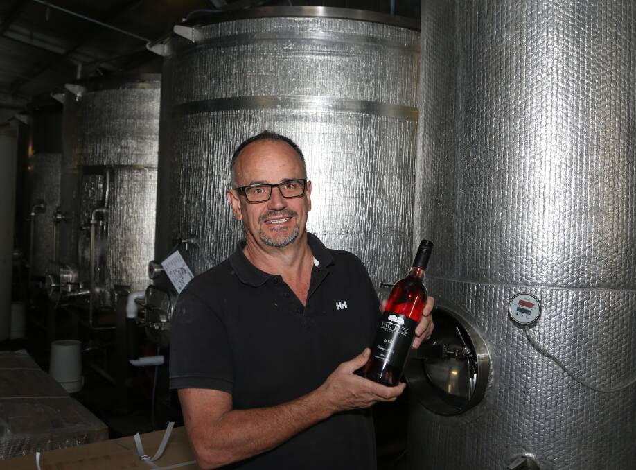 Interest from Sydney and Canberra growing: Winemaker Shane Bricker with his most recent award winning wine at Two Figs Winery. Picture: Greg Ellis.