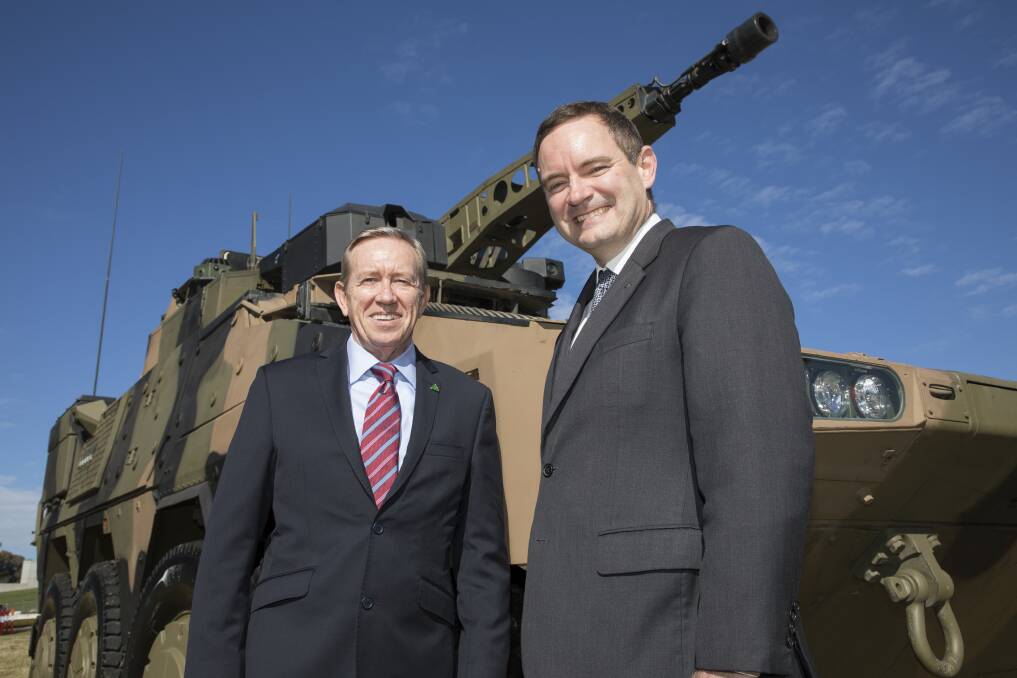 Bisalloy Steel chief executive and managing director Greg Albert with Rheinmetall Defence Australia's Gary Stewart.
