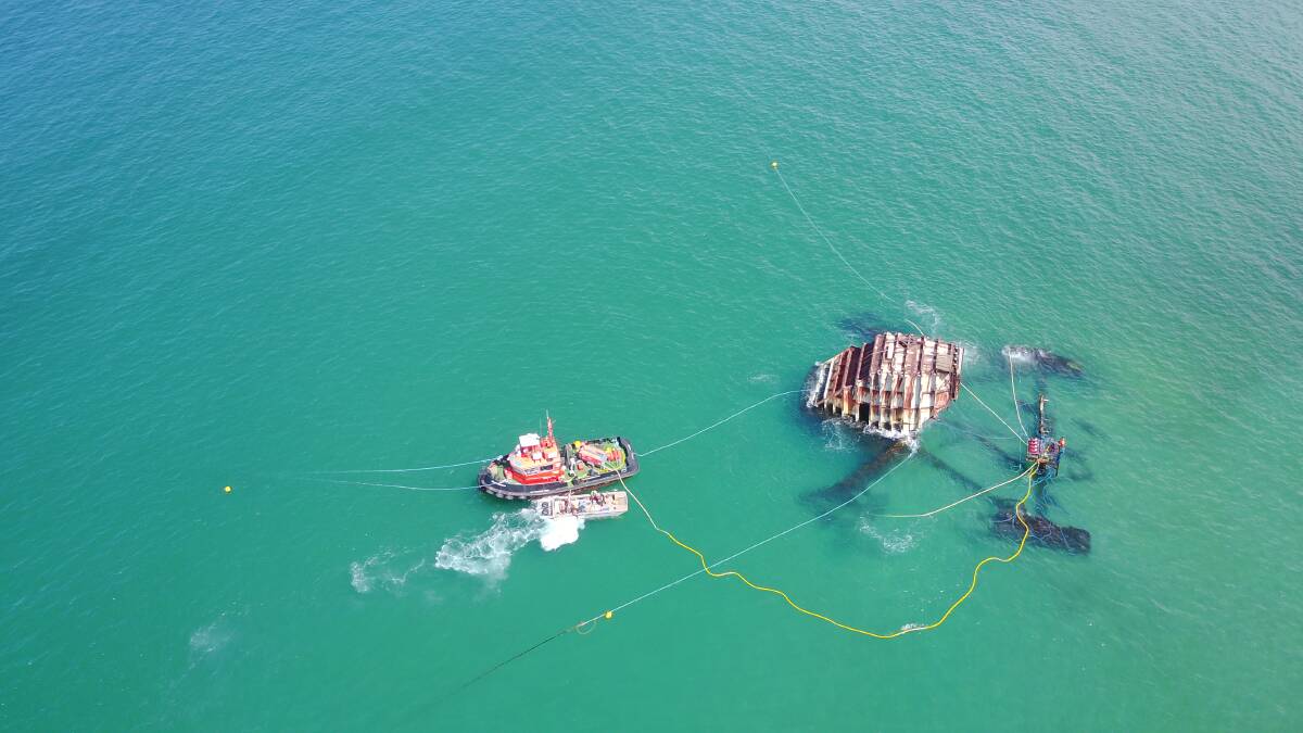 AT WORK: The old wave energy generator off the Port Kembla coal loader as captured by Carl Andrew. 