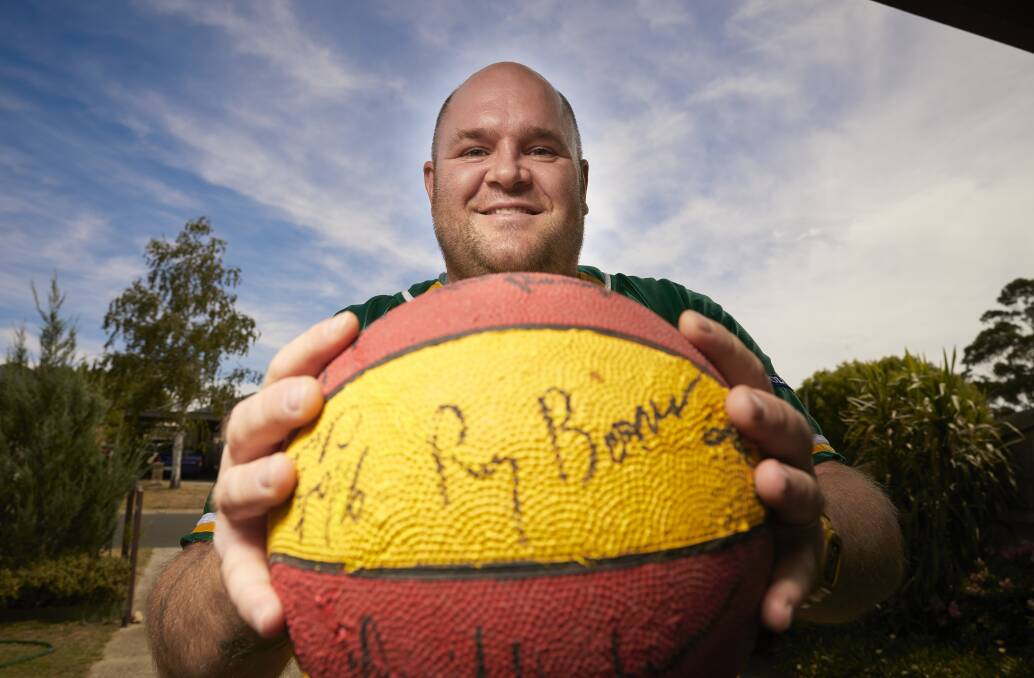 WINNERS ARE GRINNERS: Winner of the limited edition Hawks' heritage singlet Matt Jenkins with his Ray Borner-signed basketball. Picture: Luka Kauzlaric. 