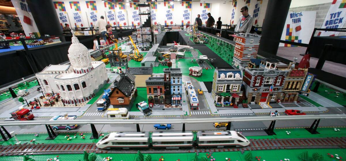 ALL ABOARD: A Lego train circles a miniature city scene at the Toy Brick Fair.