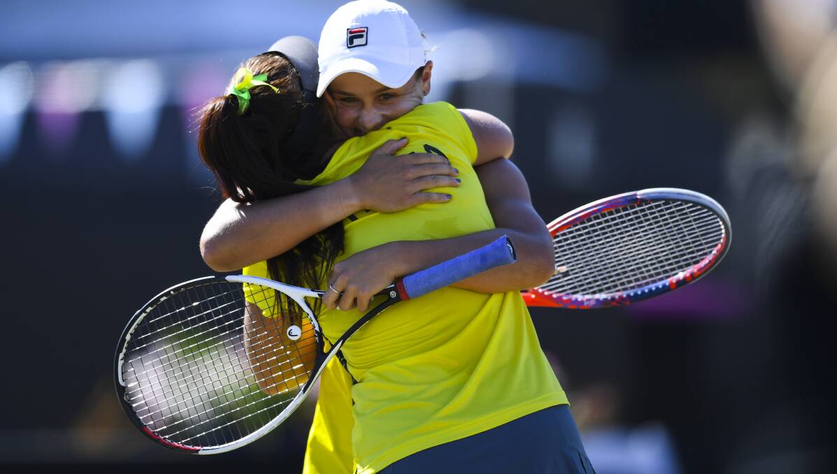 TEAM: Casey Dellacqua and Ashleigh Barty react after winning the Fed Cup tie against the Ukraine in Canberra last month.