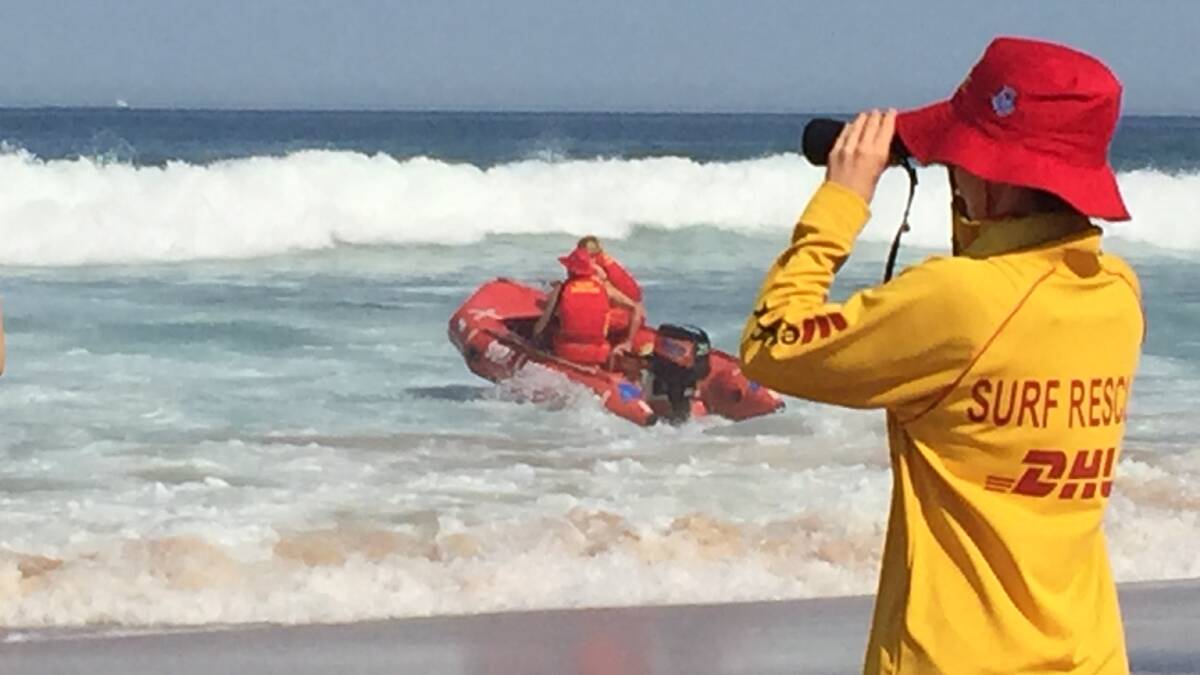 Life savers rush to rescue a swimmer in distress off Thirroul Beach on Monday afternoon. Seventy-four people were rescued at the Illawarra's 17 beaches from Stanwell Park to Windang, 22 of them were at Thirroul. Picture: Ang Thompson.