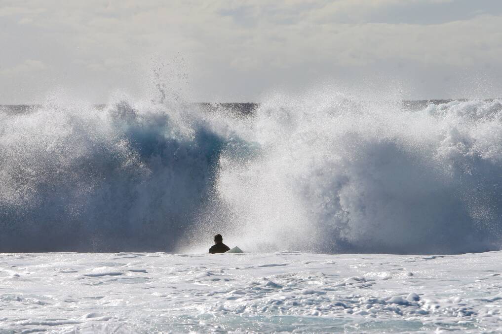 SURF'S UP: A surfer is dominated by big seas at Shellharbour earlier this month.