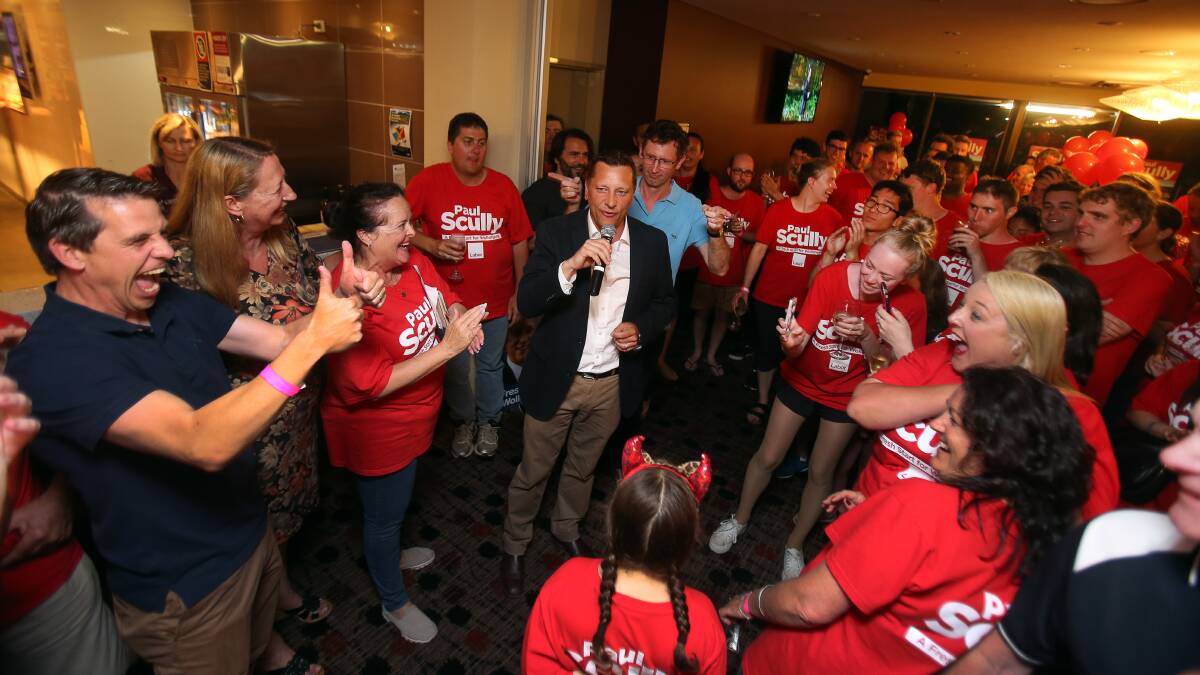 Labor candidate Paul Scully claims victory, prompting celebrations among party faithful - including the Illawarra's state and federal Labor MPs - at the Figgy Bowlo on Saturday night. Picture: Robert Peet