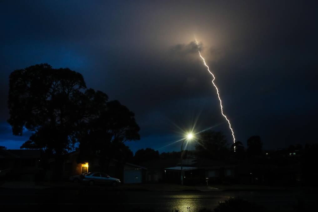 Lightning at Unanderra on Friday night. Lingering storms dumped 55mm of rain in an hour at nearby Mount Kembla. Picture: Adam McLean