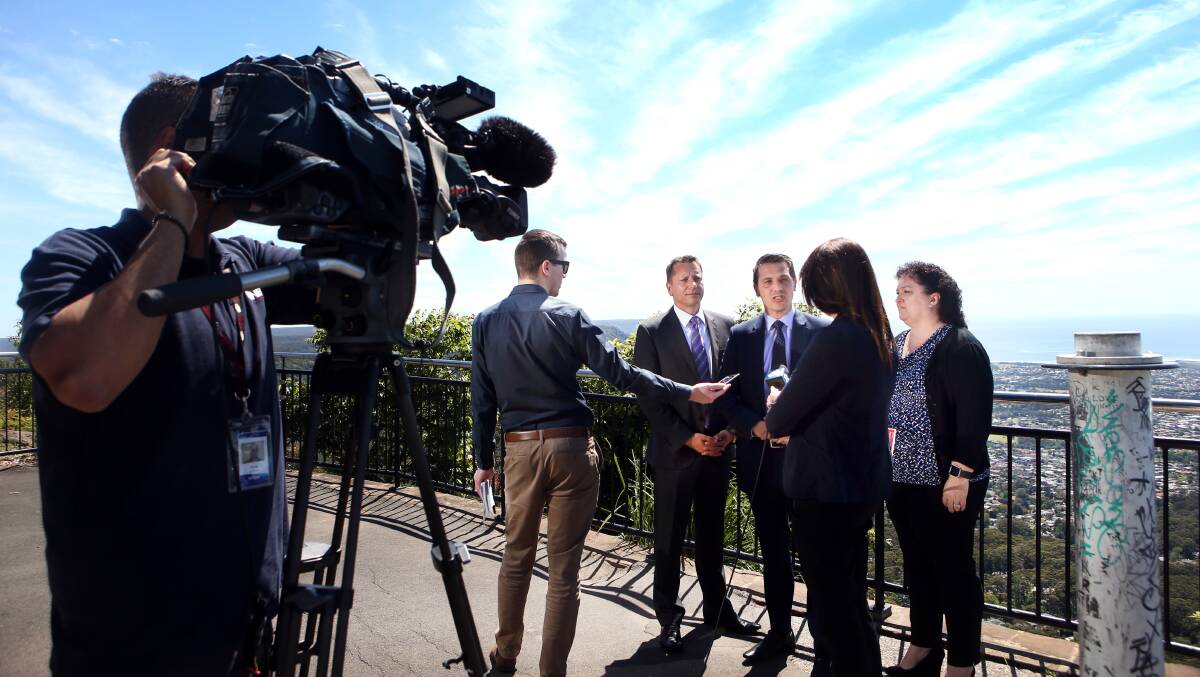 Labor's Wollongong byelection candidate Paul Scully, Keira MP Ryan Park and Destination Wollongong chairwoman Tania Brown address the media at Mount Keira Summit Park on Tuesday. Picture: Sylvia Liber