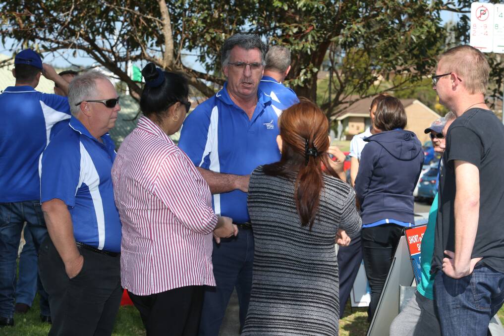 Health Services Union NSW secretary Gerard Hayes talks with affected members outside Marco Polo Unanderra Care Services. Picture: Robert Peet