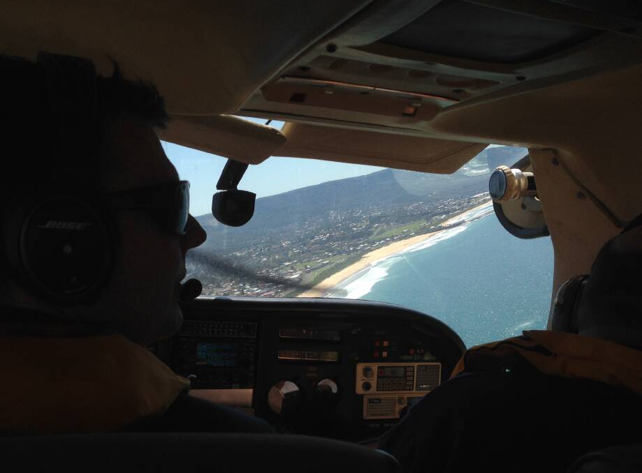 ON WATCH: Bendigo Bank Aerial Patrol pilot Andrew Jones and observer Arty Zearo search the Illawarra coast for sharks on Tuesday. Picture: Andrew Pearson
