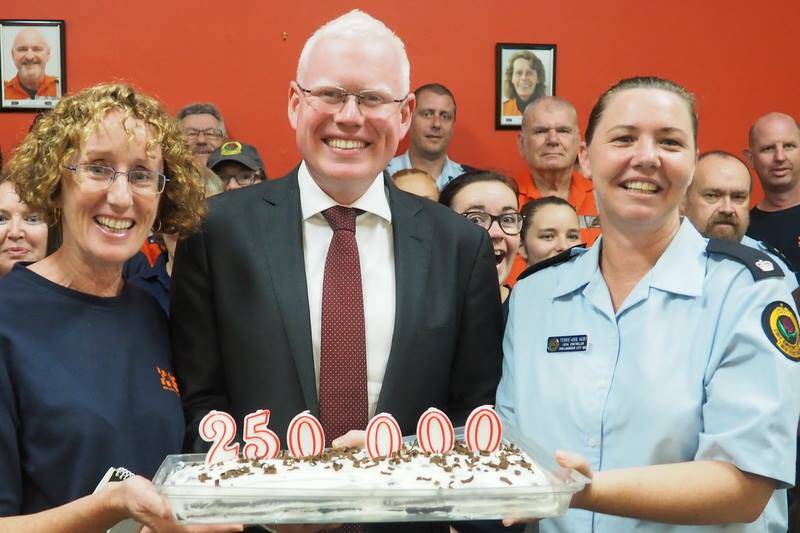 The cake's candles say it all. Parliamentary secretary for the Illawarra Gareth Ward and Terrie-Ann Hurt (left), from Shellharbour SES, celebrate the state government funding announcement. Picture: Supplied