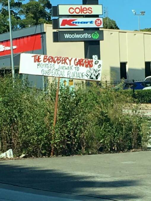 A sign that reads “The Bradbery Gardens. Figtree’s answer to Canberra’s Floriade” has been erected on the median strip of the Princes Highway outside Figtree Grove shopping centre. Picture: Supplied