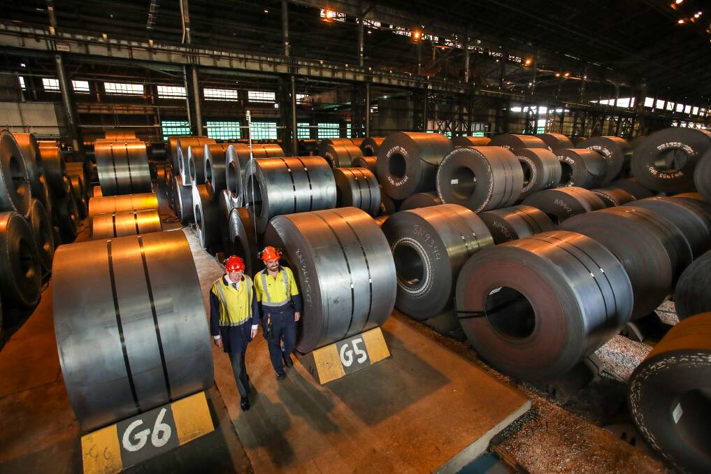 Parliamentary secretary Gareth Ward (left) and ​​Steve Christlo among hot rolled coil at the Port Kembla steelworks. Almost 30,000 tonnes of the steel is being used in the Broken Hill pipeline. Picture: Adam McLean