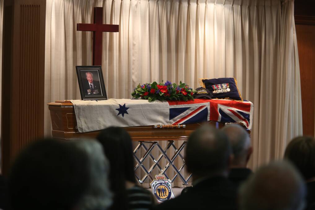 The Australian White Ensign is draped over Alan Fletcher Keys' coffin inside Hansen and Cole's Northcliffe Chapel on Friday. Mr Keys died last week at the age of 93.