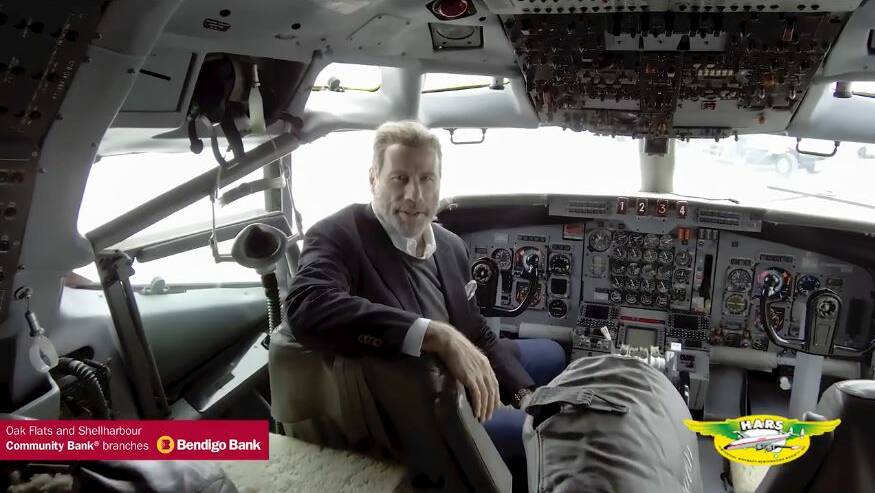A screen grab of John Travolta in the cockpit of the Boeing 707 he's donating to HARS.