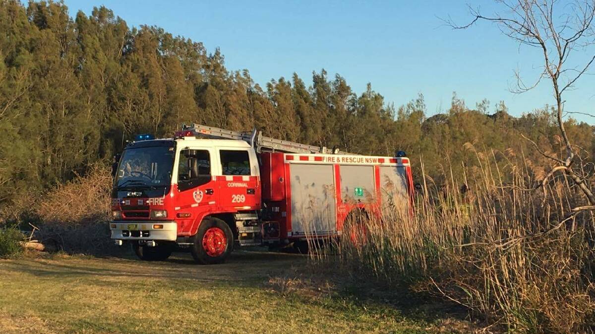 A truck from Corrimal Fire and Rescue keeps an eye on the Bellambi Lagoon fire. Picture: Gayle Tomlinson 