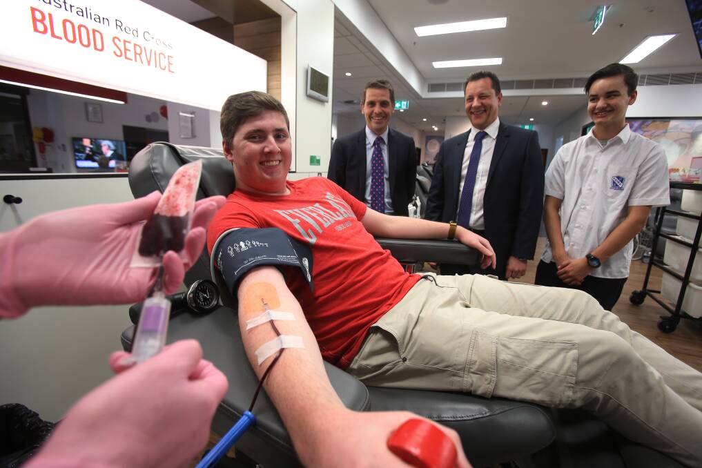 Illawarra Young Labor's Sam Noakes (left) and Sam Manns (right) with MPs Ryan Park and Paul Scully at the Wollongong blood donor centre. Picture: Robert Peet