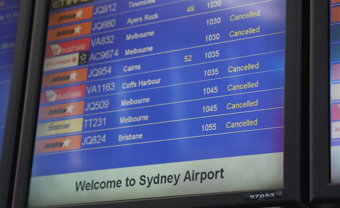 An information screen shows some of the cancelled flights at Sydney Domestic Airport on Monday. Virgin Australia, Qantas and Jetstar have confirmed the problem is affecting flights. Picture: Daniel Munoz / AAP