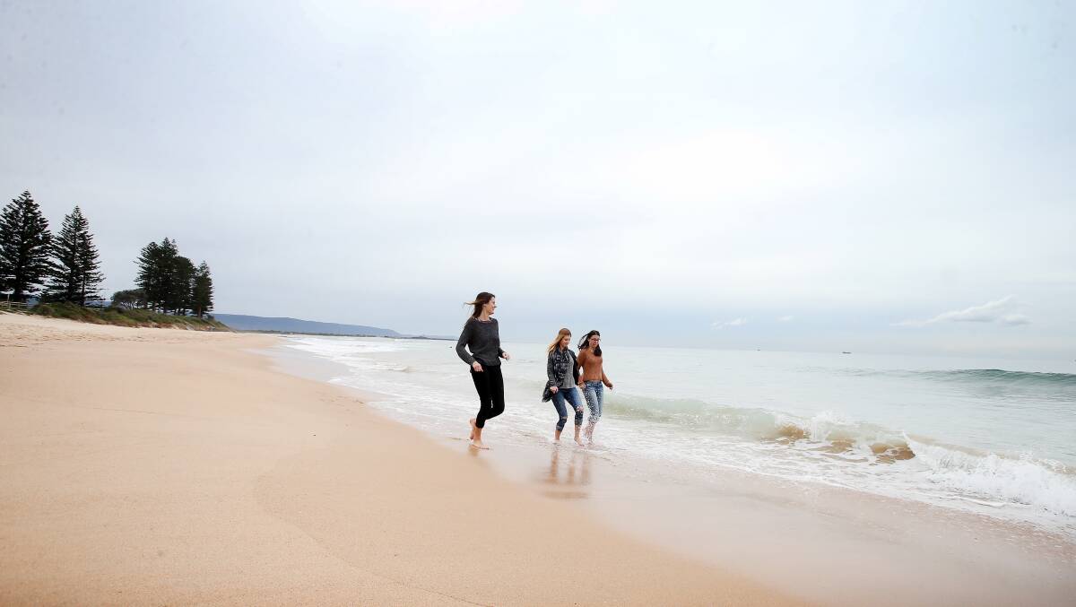 Inga Skarps, Katarina Rajkovaca and Renee Pyers enjoy North Wollongong beach on Monday, despite the cooler conditions. A shower or two is forecast in Wollongong on Tuesday, with the rain to set in on Wednesday. Picture: Sylvia Liber