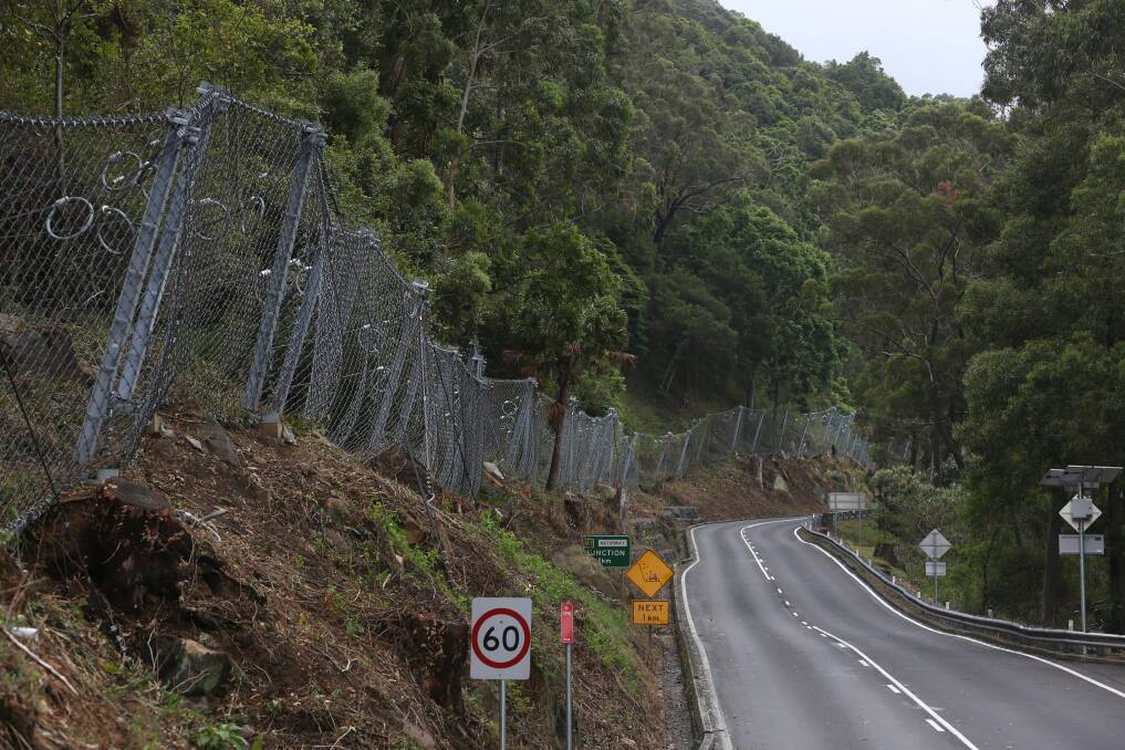 ACCOLADE: The Roads and Maritime Services team behind the new 1.1km rockfall fence on Bulli Pass have won an engineering award for their work. Picture: Robert Peet