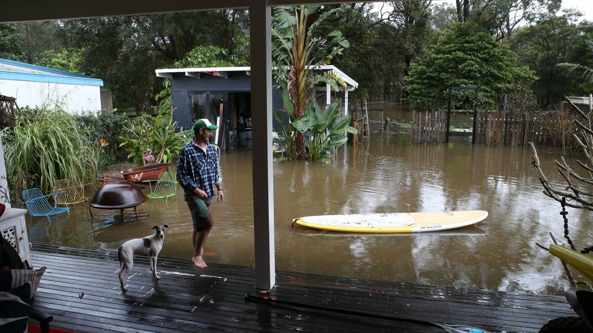 FLOODED: Chris White in his Hay Avenue, Shoalhaven Heads, backyard. It was surrounded by rising waters from the Shoalhaven River on August 26. Picture: Kirk Gilmour

